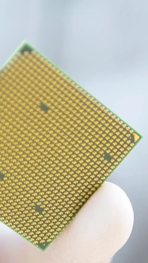 Technician hand with glove holds microprocessor with gold cpu pins 스톡 동영상 319593423