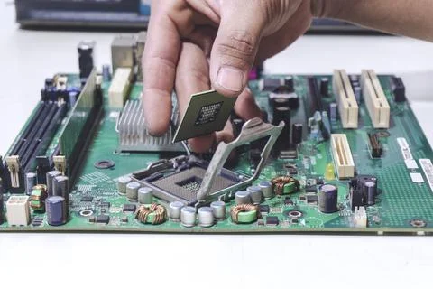 Technician hand holding the CPU for fixing and upgrade computer pc to repai.. Stock Photos