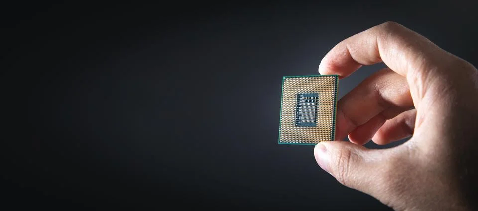 Technician hand holding cpu processor of pc. 写真素材