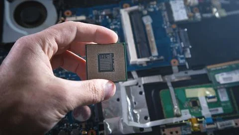 Technician hand holding cpu processor of pc. 写真素材