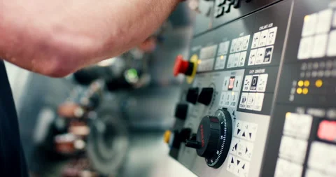 Technician hand operating control panel of industrial CNC machine in factory Stockbeeldmateriaal 329677792