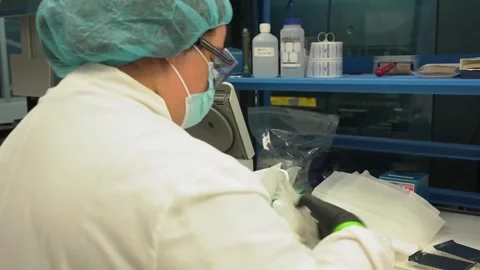 A technician handles sample tubes at a laboratory bench at a crime laboratory Stock Footage 345299206
