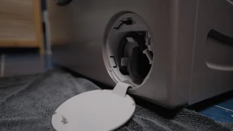 Technician hands cleaning lint filter of washing machine during routine Stock Footage 313300800