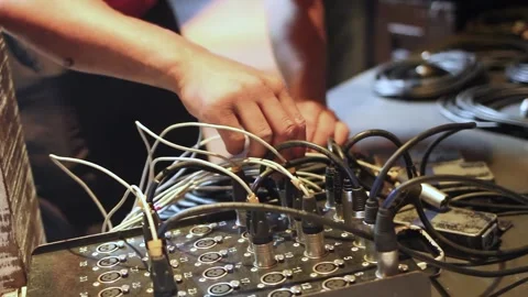 Technician hands plugging in sound equipment before concert 스톡 동영상 255680904