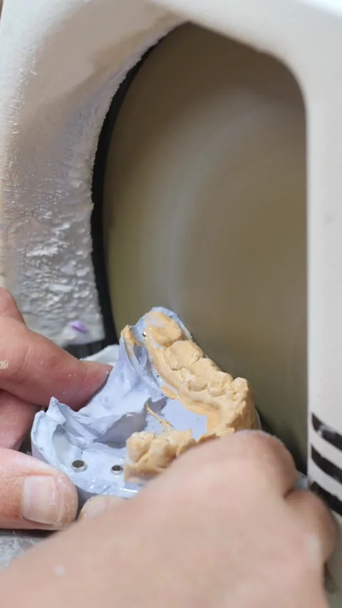 Technician hands shape dental model using grinding machine in medical laboratory Video stock 321304077
