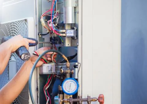 Technician hands using a screwdriver fixing modern air conditioner, Maintenance Photos