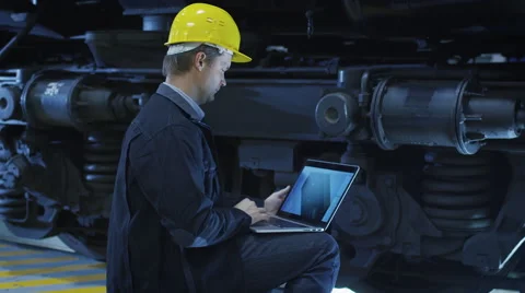 Technician in Hard Hat Using CAD Program on Laptop Stock Footage 56231550