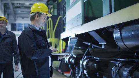 Technician in Hard Hat Using CAD Program on Laptop Stock Footage 56231781