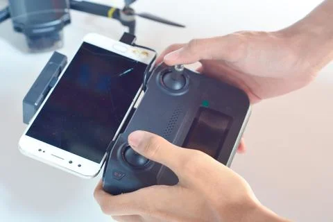 A technician is holding a drone remote control Stock Photos