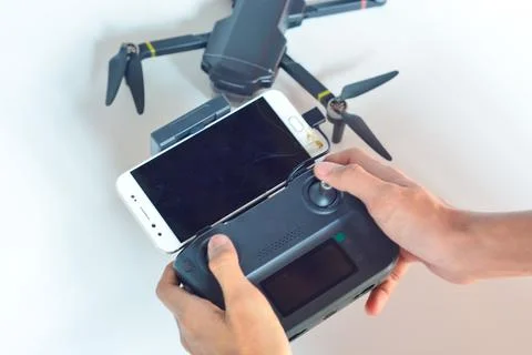 A technician is holding a drone remote control Stock Photos