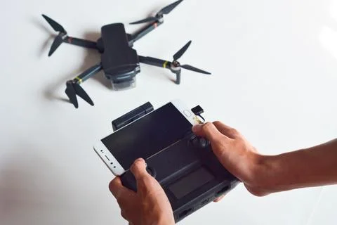 A technician is holding a drone remote control Stock Photos