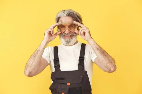 Technician holding instruments on a yellow background Foto stock