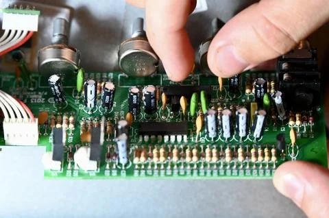 Technician Holding Printed Circuit Board During Electronics Repair and Assemb Stock Photos