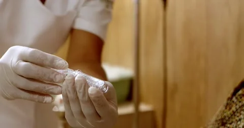 Technician Holding Test Tube During Laboratory Procedure, Brazil Stockbeeldmateriaal 334555009