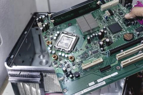 The technician holds a board computer pc for the upgrade to repair inside T.. Stock Photos