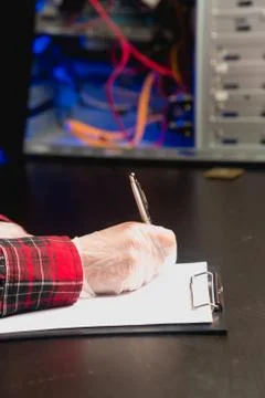 The technician holds a handle on a white tablet, describing the characteristi Stock Photos