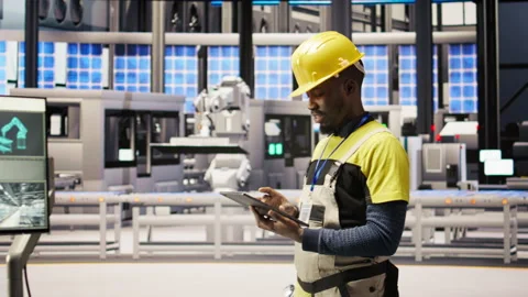 Technician in industrial plant using tablet app to diagnose equipment errors Stock Footage 307364324