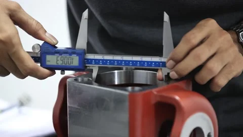 Technician inspect OD dimensions of high end industrial part with micrometer. Video stock 303458338
