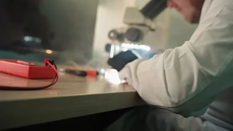 Technician Inspecting Electronics with Microscope in Lab Setup Video stock 281374307