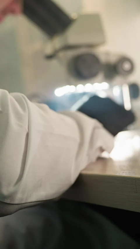 Technician Inspecting Electronics with Microscope in Lab Setup Video stock 310490676