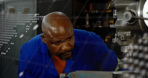 Technician inspecting machine alignment as translucent map overlay fading for Stock Footage 310670938