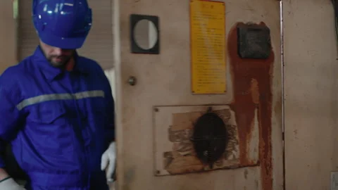 Technician inspecting main switch board in factory Stock Footage 257157518