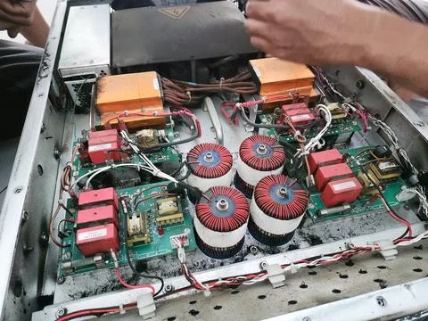 Technician Inspecting Open Power Electronics Cabinet Stock Photos