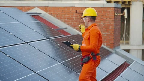 Technician inspecting solar panels on rooftop Video stock 343894886