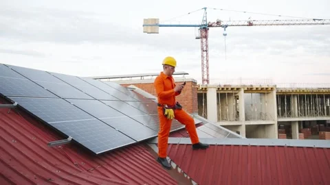 Technician inspecting solar panels on a rooftop Stock Footage 343894991