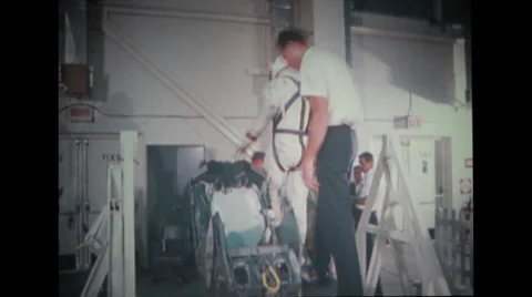 Technician inspecting spacecraft couch Stock Footage 37596985