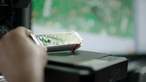 Technician Inspects Exposed Circuit Board of Electronic Device in Laboratory Video stock 334429687