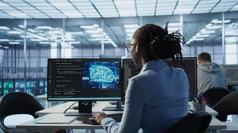 Technician inspects rackmounts in server room using artificial intelligence tech Stock Photos