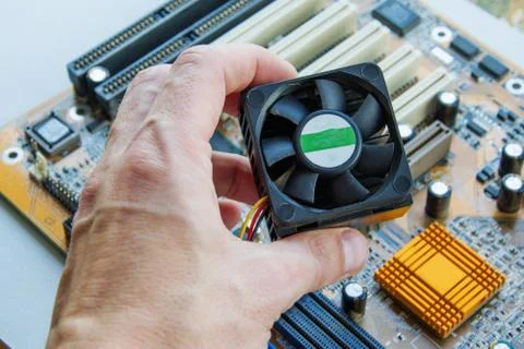 Technician install CPU cooler on modern PC computer motherboard. The process  Stock Photos
