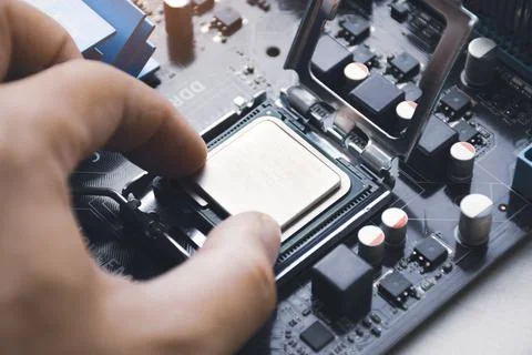 Technician install CPU processor chip Stock Photos