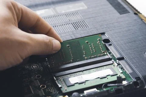 Technician install new RAM to memory slot Stock Photos