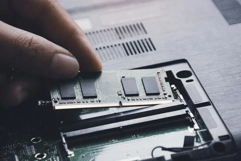 Technician install new RAM (Random-access memory) to memory slot  Stock Photos