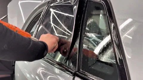 Technician Installing car window tint. Window toned film. Stock Footage 331116692