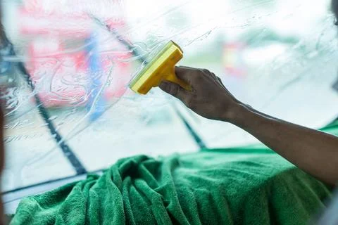 Technician Installing car window tint. Car window tinting series. Stock Photos