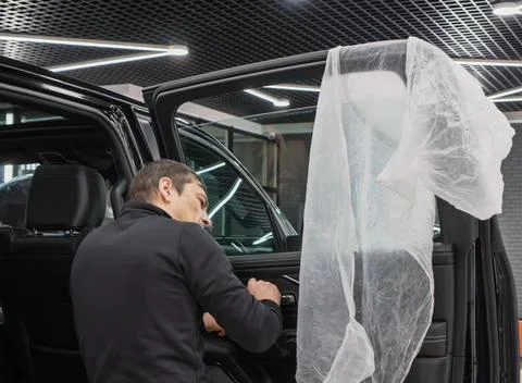 Technician Installing car window tint. Stock Photos