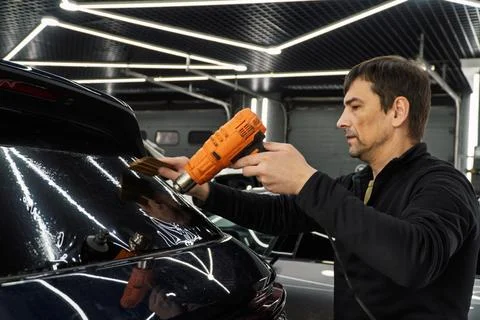 Technician Installing car window tint. Car window tinting series. Car windo.. Stock Photos
