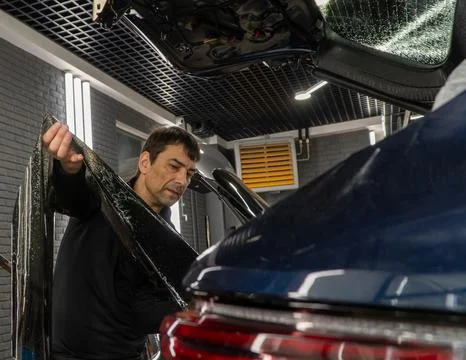 Technician Installing car window tint. Car window tinting series. Car windo.. Stock Photos