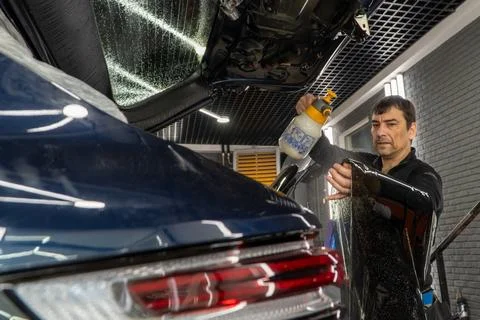 Technician Installing car window tint. Car window tinting series. Car windo.. Stock Photos