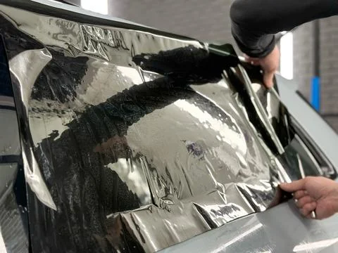 Technician Installing car window tint. Window toned film. Car window tintin.. Stock Photos