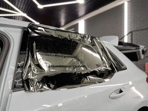 Technician Installing car window tint. Window toned film. Car window tintin.. Stock Photos