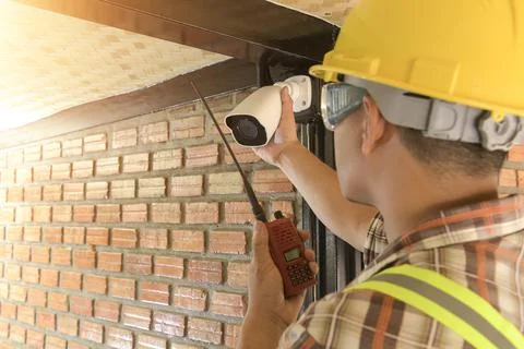 Technician installing CCTV camera for security Stock Photos