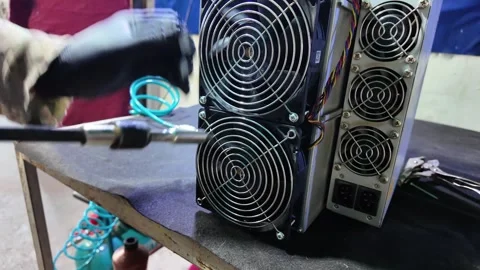 Technician Installing Cooling Fan on Bitcoin ASIC Mining Hardware Stock Footage 323796598