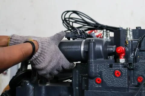 Technician Installing a Cylindrical Filter or Component on Industrial Machi.. Stock Photos