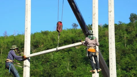 Technician installing equipment for high voltage electrical work on site Stock Footage 248156064
