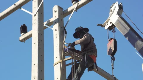 Technician installing equipment for high voltage electrical work on site Stock Footage 248157834