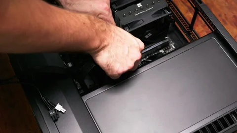 Technician installing GPU in desktop computer. Perfect for tech tutorials and Stock Footage 301636656